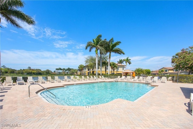 community pool featuring a patio area and fence