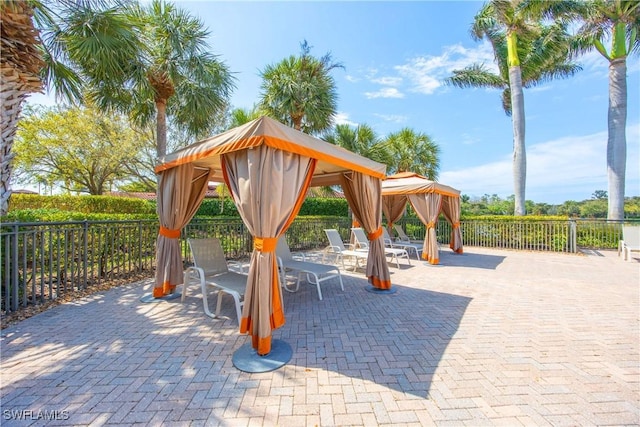 surrounding community featuring a patio area, fence, and a gazebo