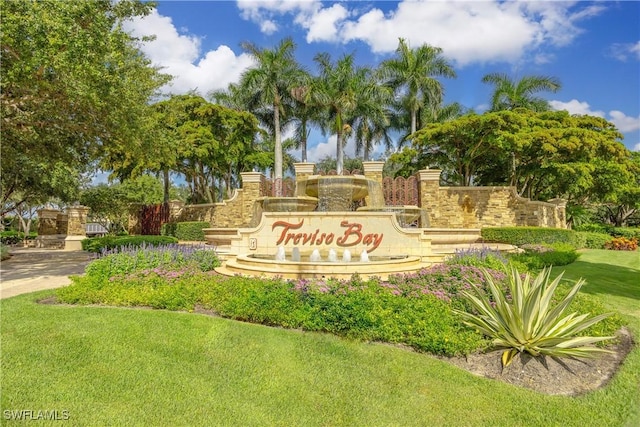 community sign featuring a lawn