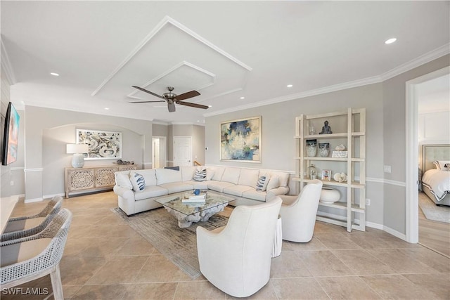 living area with light tile patterned floors, baseboards, a ceiling fan, crown molding, and recessed lighting