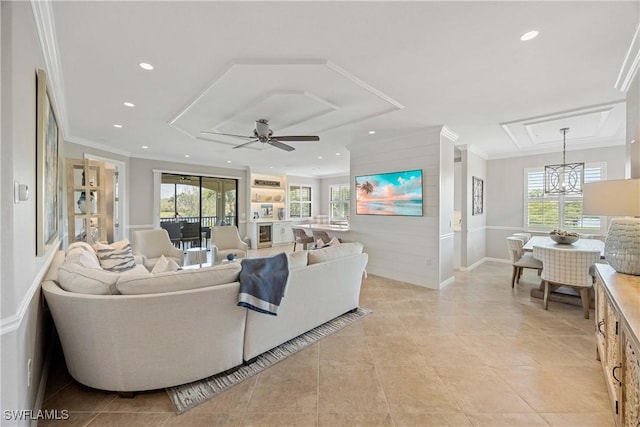 living room featuring crown molding, ceiling fan with notable chandelier, a wealth of natural light, and recessed lighting