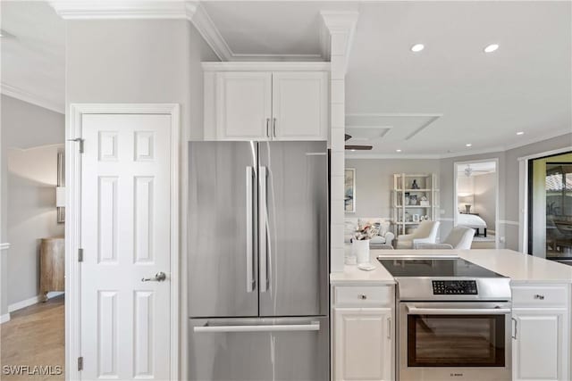 kitchen with appliances with stainless steel finishes, light countertops, white cabinetry, and ornamental molding