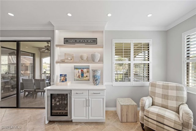 bar with light tile patterned floors, wine cooler, crown molding, and recessed lighting