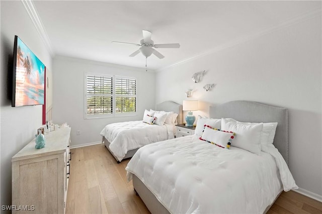 bedroom featuring baseboards, light wood-style flooring, and crown molding