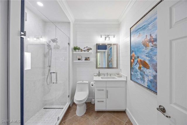 bathroom with ornamental molding, tile patterned flooring, a shower stall, and vanity