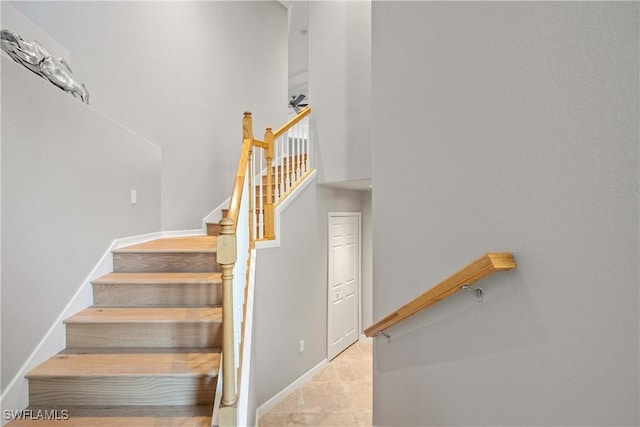 staircase featuring baseboards