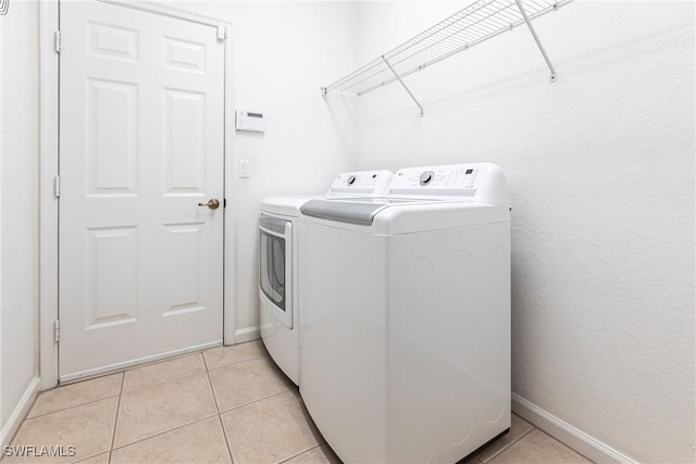 12020 Bramble Cove Dr, Fort Myers, FL 33905 - clothes washing area with separate washer and dryer, light tile patterned floors, baseboards, and laundry area