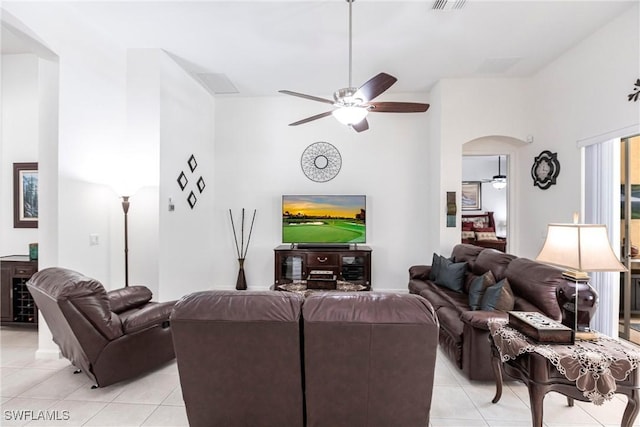 12020 Bramble Cove Dr, Fort Myers, FL 33905 - living room with a ceiling fan, visible vents, arched walkways, and light tile patterned floors