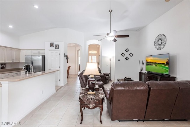 12020 Bramble Cove Dr, Fort Myers, FL 33905 - living room featuring light tile patterned flooring, lofted ceiling, arched walkways, ceiling fan, and recessed lighting