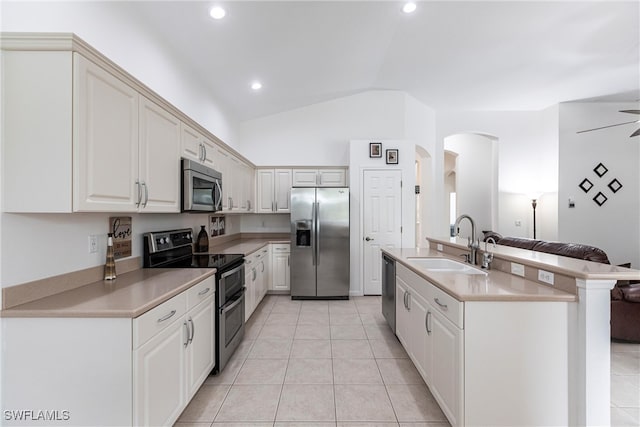 12020 Bramble Cove Dr, Fort Myers, FL 33905 - kitchen featuring light countertops, a sink, light tile patterned floors, stainless steel appliances, and arched walkways