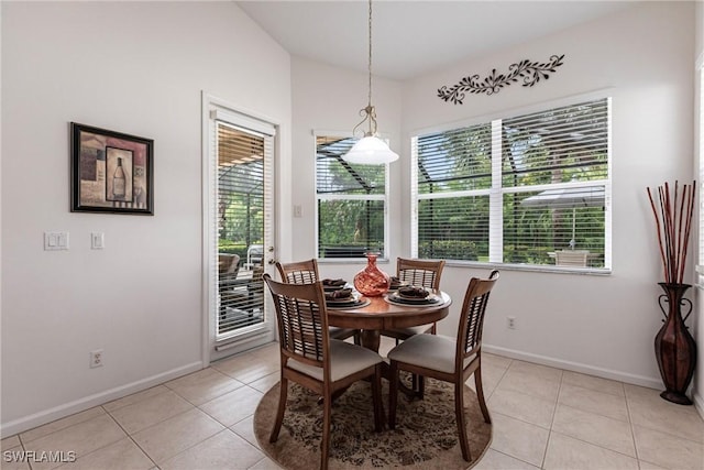 12020 Bramble Cove Dr, Fort Myers, FL 33905 - dining space featuring baseboards, vaulted ceiling, and light tile patterned floors