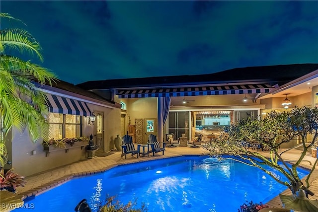 834 Coldstream Ct, Naples, FL 34104 - pool at night with a patio and an outdoor pool