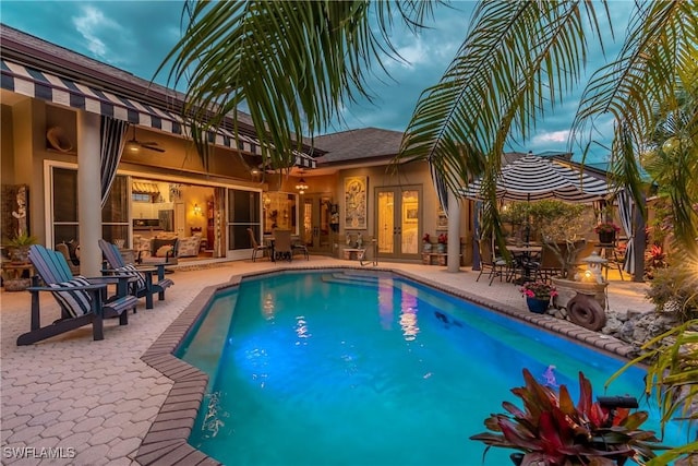 834 Coldstream Ct, Naples, FL 34104 - swimming pool with french doors and a patio area