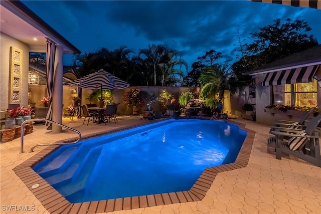 834 Coldstream Ct, Naples, FL 34104 - pool at night with a patio area and a fenced backyard