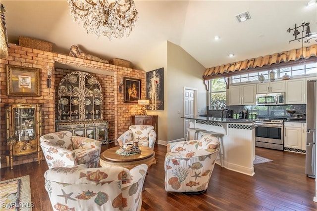 834 Coldstream Ct, Naples, FL 34104 - living area with lofted ceiling, dark wood finished floors, and a chandelier