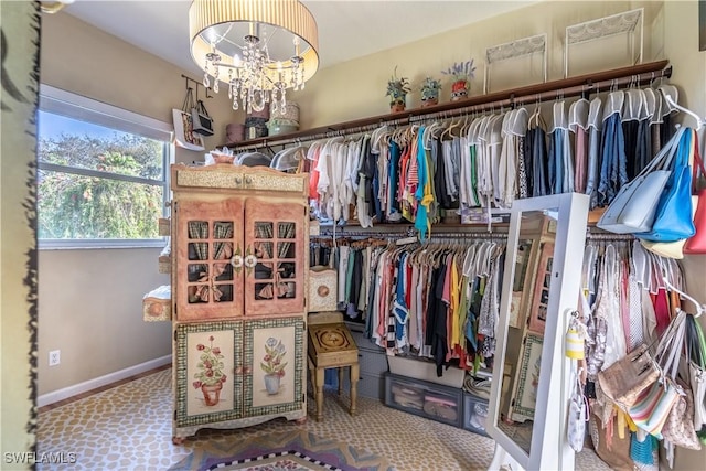 834 Coldstream Ct, Naples, FL 34104 - walk in closet featuring a chandelier