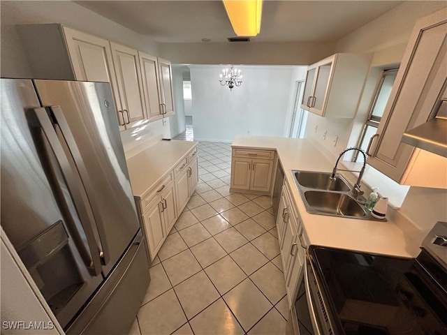 kitchen with light tile patterned flooring, a sink, visible vents, light countertops, and appliances with stainless steel finishes