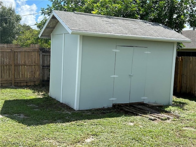 view of shed featuring fence