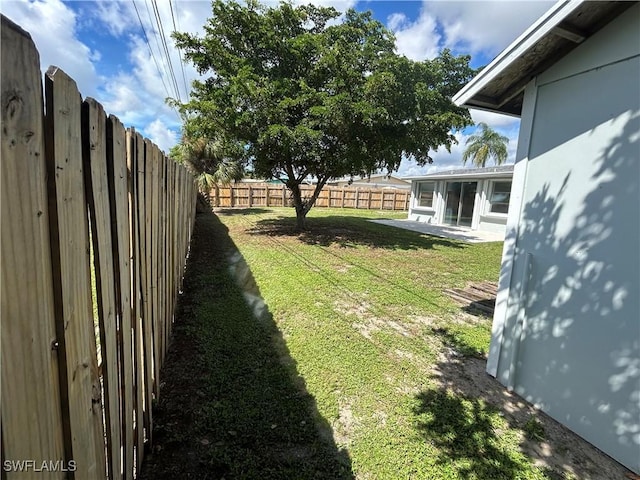 view of yard with a fenced backyard