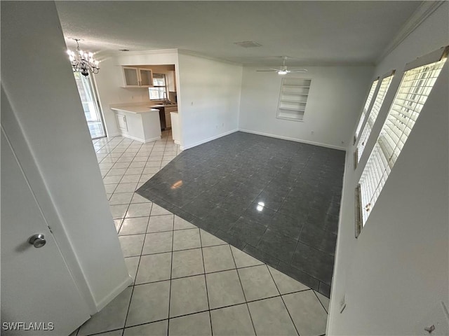 interior space with light tile patterned floors, baseboards, ornamental molding, and ceiling fan with notable chandelier