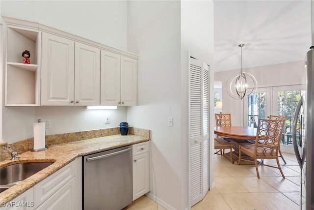 kitchen with stainless steel appliances, light stone countertops, white cabinetry, and open shelves