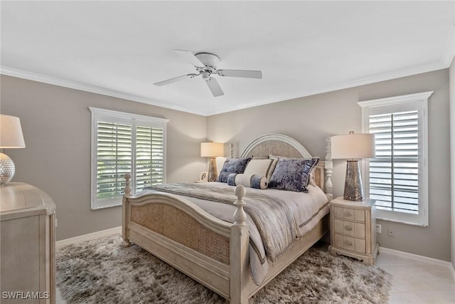 bedroom featuring ceiling fan, multiple windows, baseboards, and crown molding