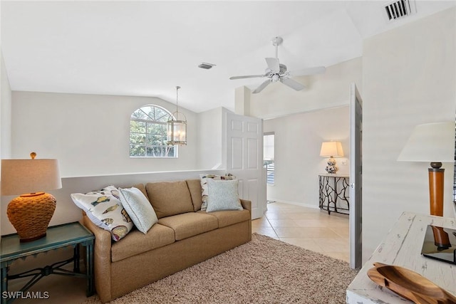 tiled living room with lofted ceiling, carpet floors, visible vents, and ceiling fan with notable chandelier