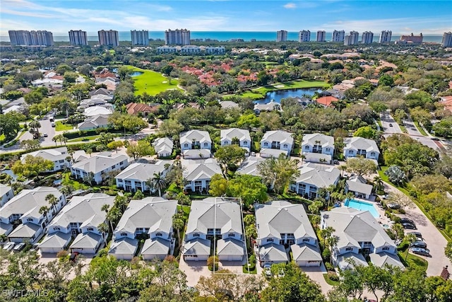 drone / aerial view featuring a water view and a residential view