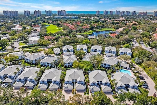 view of urban area featuring a nearby body of water and nearby suburban area