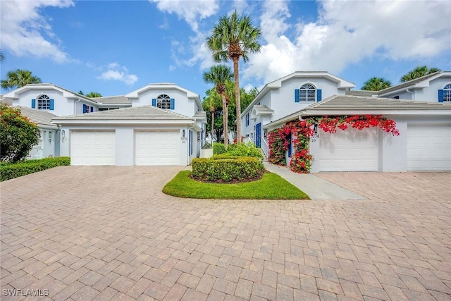 7070 Barrington Cir Unit 202, Naples, FL 34108 - traditional home with decorative driveway, a garage, and stucco siding