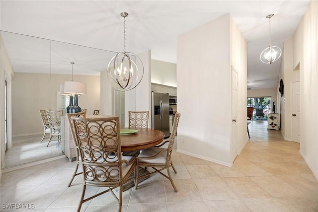 7070 Barrington Cir Unit 202, Naples, FL 34108 - dining area featuring a chandelier, light tile patterned flooring, and baseboards