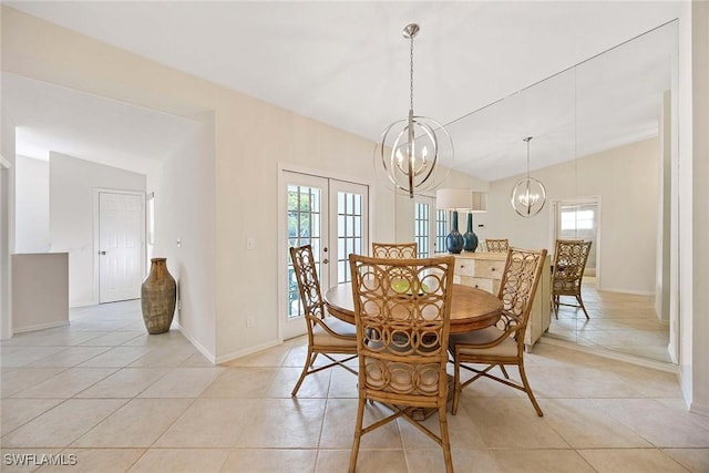 7070 Barrington Cir Unit 202, Naples, FL 34108 - dining room with a chandelier, vaulted ceiling, light tile patterned floors, baseboards, and french doors