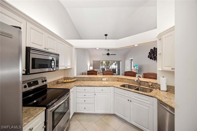 7070 Barrington Cir Unit 202, Naples, FL 34108 - kitchen with stainless steel appliances, a sink, ceiling fan, vaulted ceiling, and light tile patterned floors