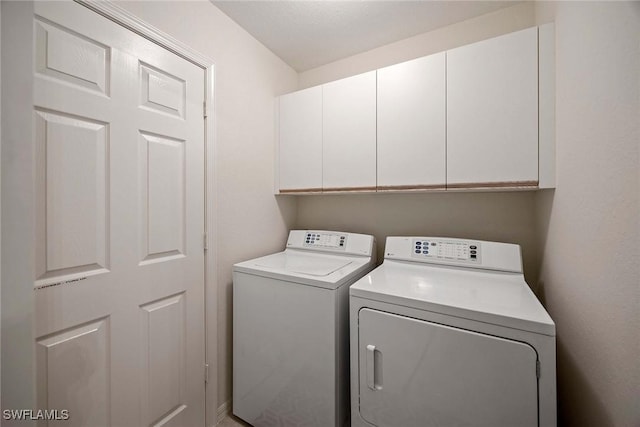 7070 Barrington Cir Unit 202, Naples, FL 34108 - washroom with cabinet space and washing machine and dryer