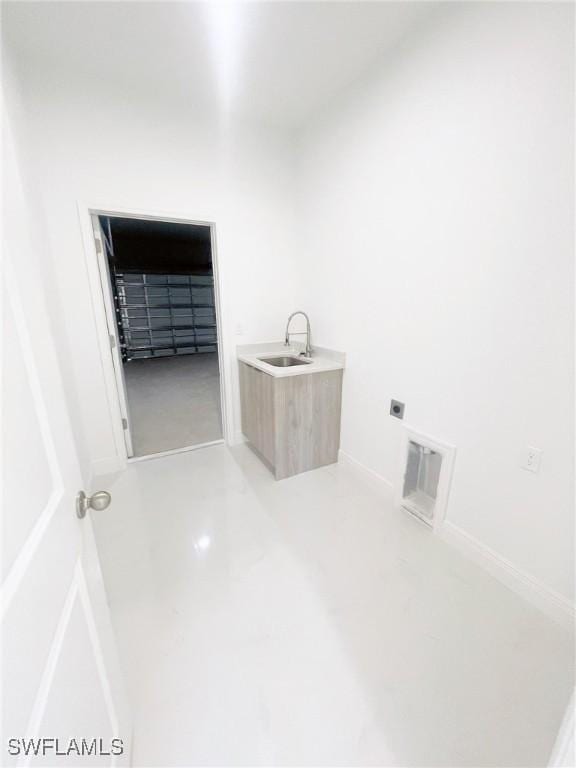 laundry area with laundry area, visible vents, electric dryer hookup, and a sink