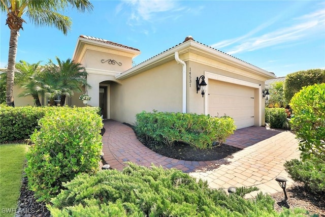 exterior space featuring a garage and stucco siding