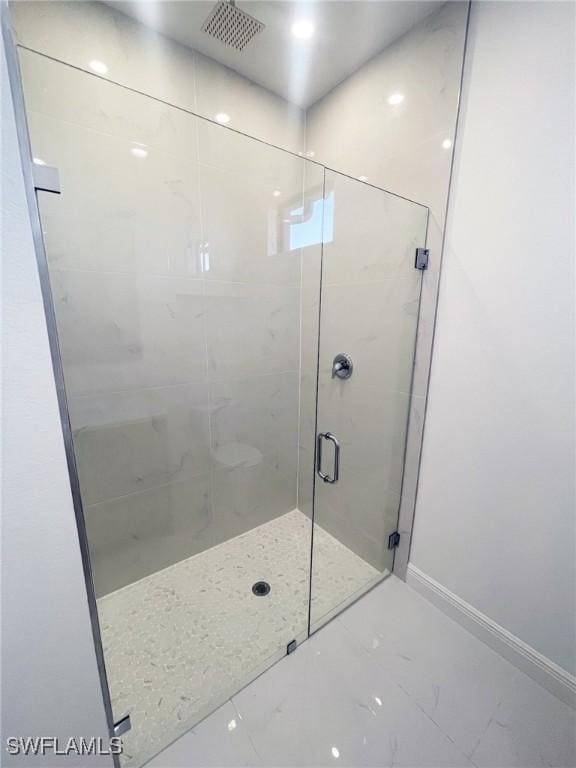 bathroom featuring visible vents, a shower stall, and baseboards