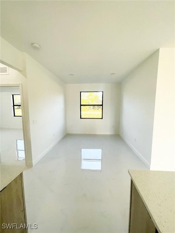 spare room featuring visible vents and baseboards