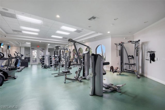 workout area featuring baseboards, visible vents, crown molding, and a paneled ceiling