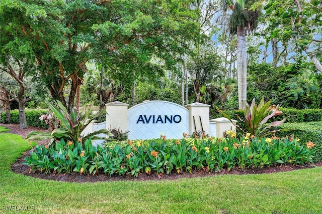 community sign featuring a lawn