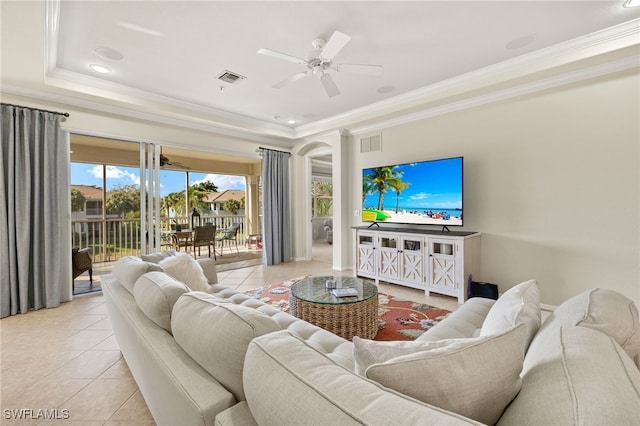 living area featuring visible vents, a tray ceiling, a ceiling fan, and light tile patterned flooring