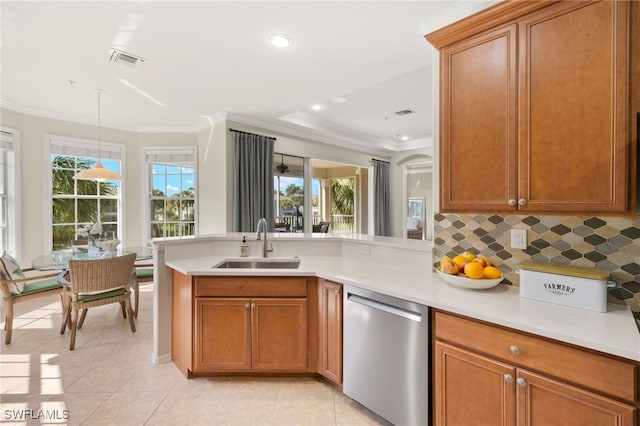kitchen featuring stainless steel dishwasher, a sink, visible vents, light countertops, and a peninsula