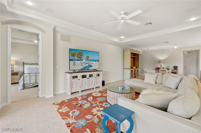 living area featuring a ceiling fan, visible vents, crown molding, and light tile patterned floors