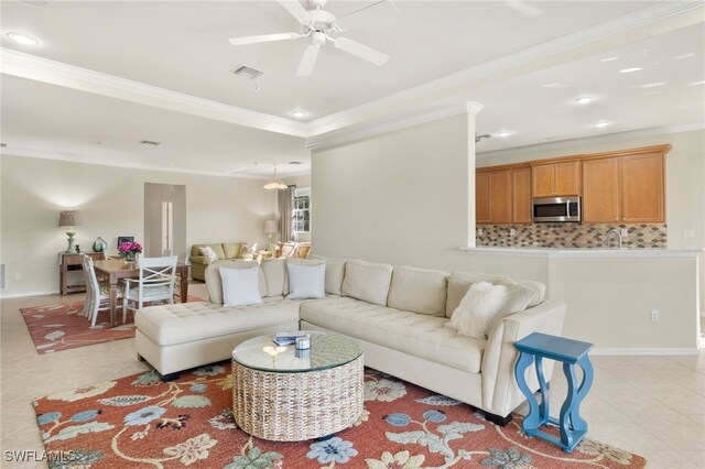 living room featuring light tile patterned floors, recessed lighting, visible vents, ornamental molding, and baseboards