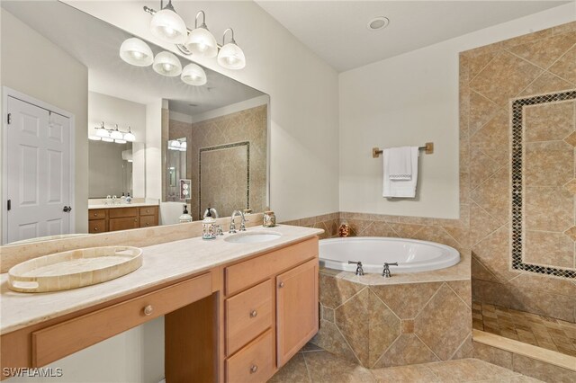 bathroom featuring tile patterned floors, a garden tub, vanity, and a walk in shower