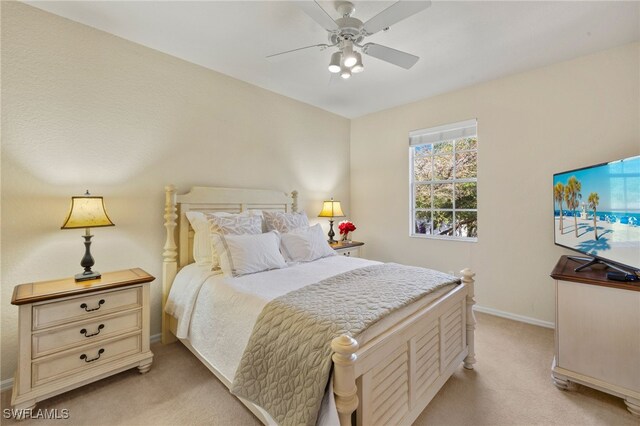 bedroom with baseboards, ceiling fan, and light colored carpet