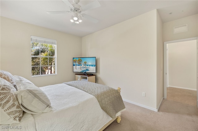 carpeted bedroom featuring ceiling fan, visible vents, and baseboards