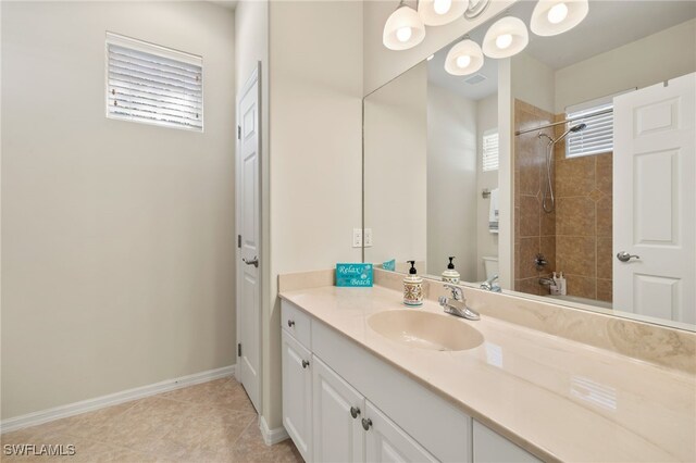 full bathroom with baseboards, toilet, tile patterned flooring, walk in shower, and vanity