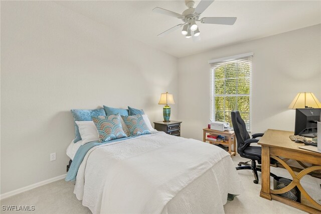 bedroom featuring light colored carpet, ceiling fan, and baseboards