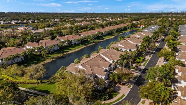 drone / aerial view featuring a water view and a residential view